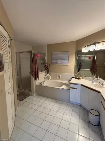a bathroom with a granite countertop sink mirror and bathtub