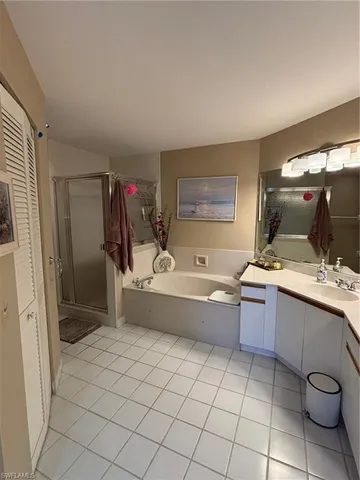 a bathroom with a granite countertop sink mirror and bathtub
