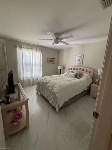 a bedroom with bed and a window