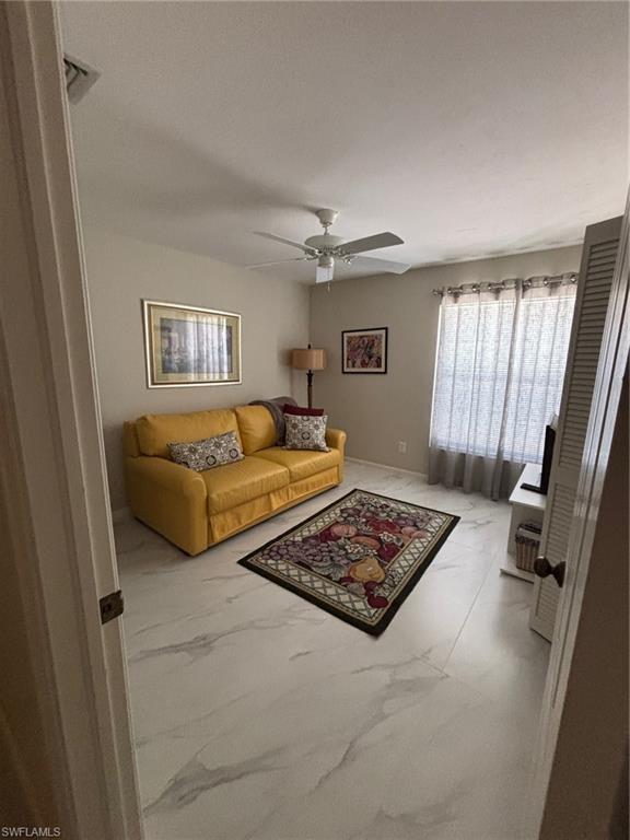 6225 Bellerive Avenue, Unit 1504 Naples, FL 34119 - Photo 13 of 18 a bedroom with furniture and a window