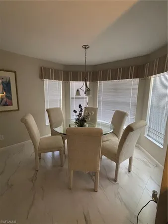 a living room with furniture and a ceiling fan