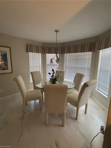 a living room with furniture and a ceiling fan