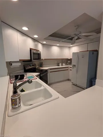 a kitchen with refrigerator and microwave