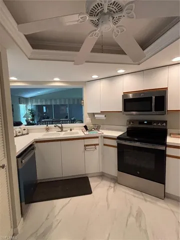 a kitchen with a sink appliances and cabinets