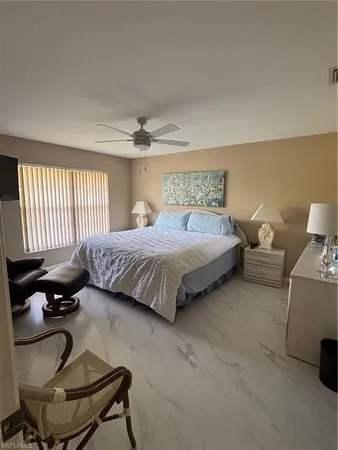 a bedroom with a bed and glass windows