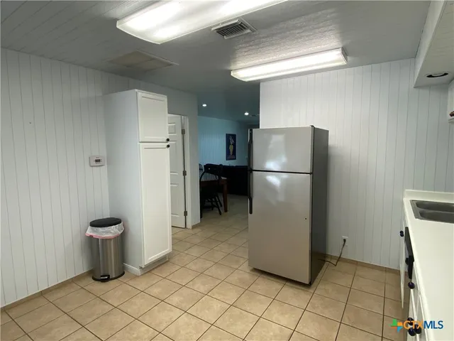 a kitchen with a refrigerator and a stove