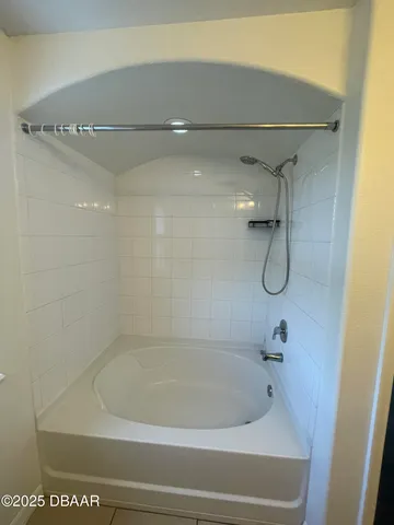 a bath tub sitting next to a shower