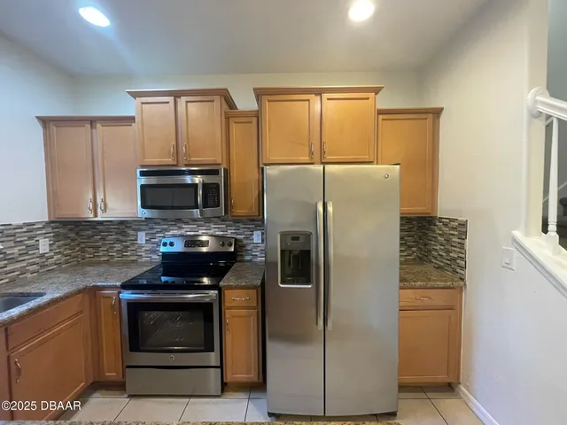 a kitchen with a refrigerator stove and microwave