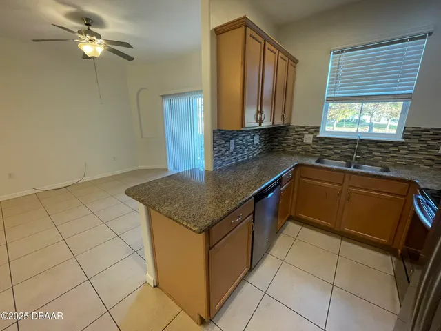 a kitchen with a sink cabinets and window