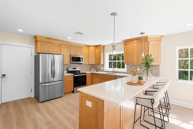 a view of a dining room with furniture and a kitchen