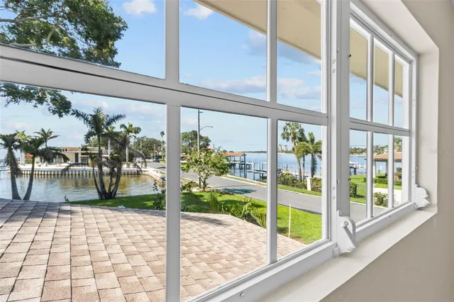 a view of a patio with table and chairs and potted plants