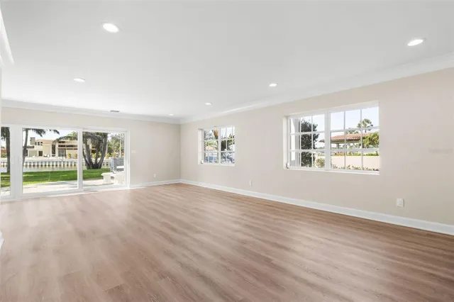 a large kitchen with kitchen island a large window and stainless steel appliances