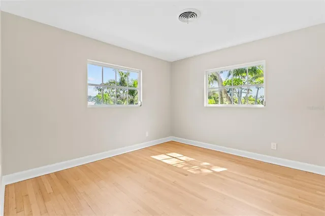 an empty room with windows and closet