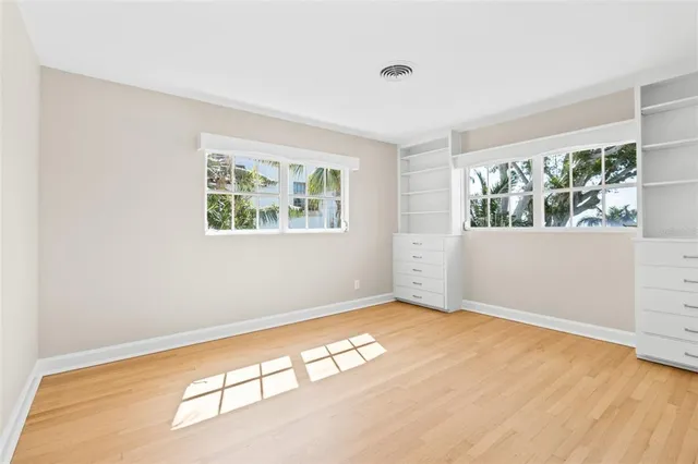 a view of an empty room and wooden floor