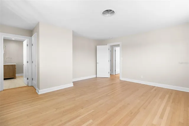 a view of an empty room with windows