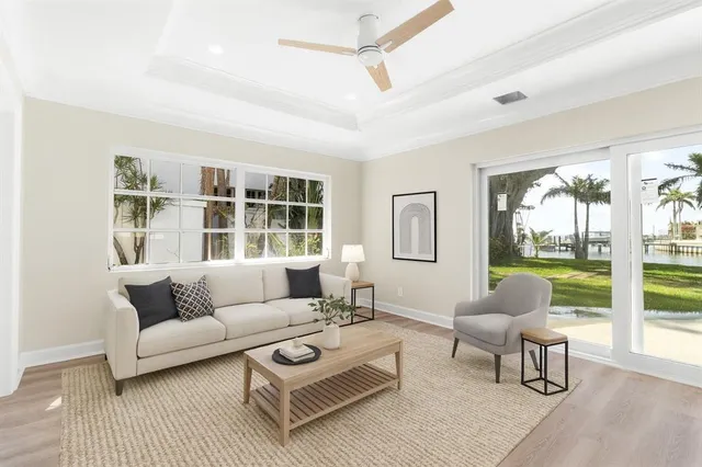 a living room with furniture and view of kitchen