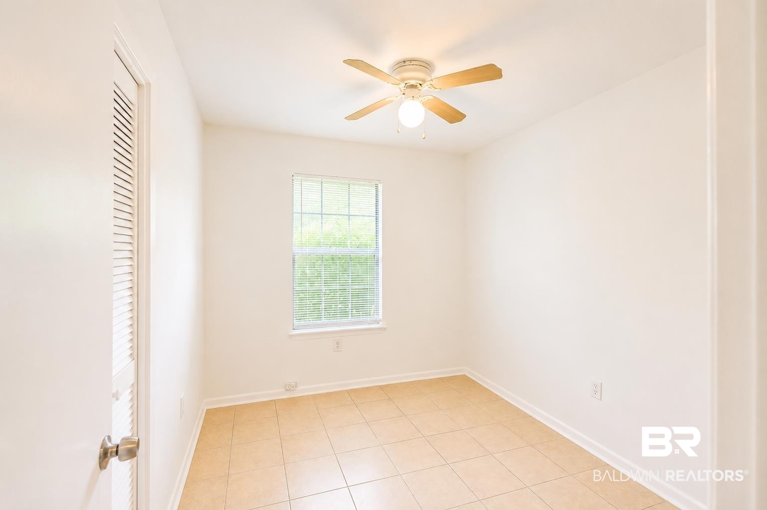 614 East Gate Circle Foley, AL 36535 - Photo 16 of 31 Neutral-toned room with tile flooring, a single window, and a ceiling fan with integrated lighting