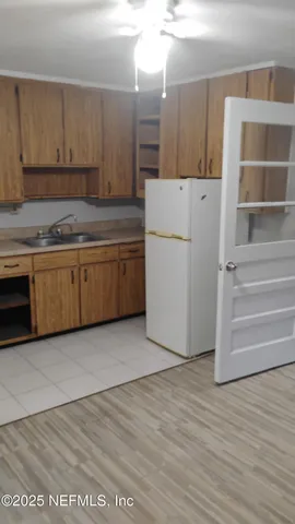 a kitchen with granite countertop a cabinets and white appliances
