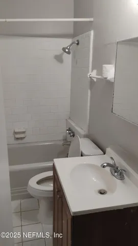 a bathroom with a sink toilet and a mirror