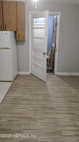 a view of walk in closet with clothes