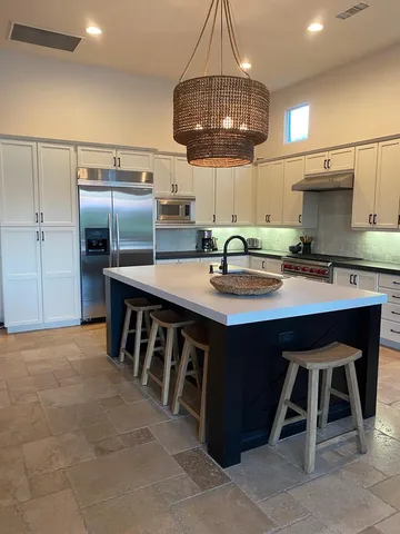 a bedroom with furniture and a large window