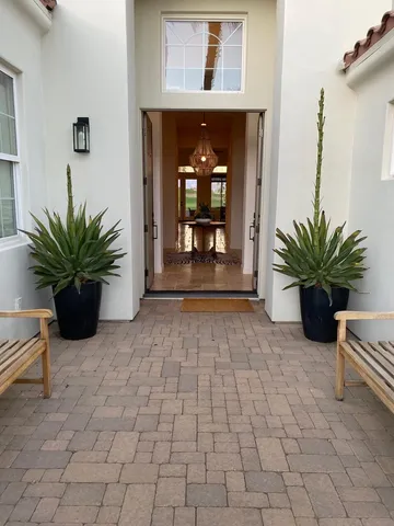 a entryway view with a potted plant in front of it