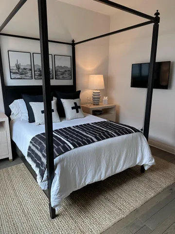 a view of a patio with chairs and a small yard