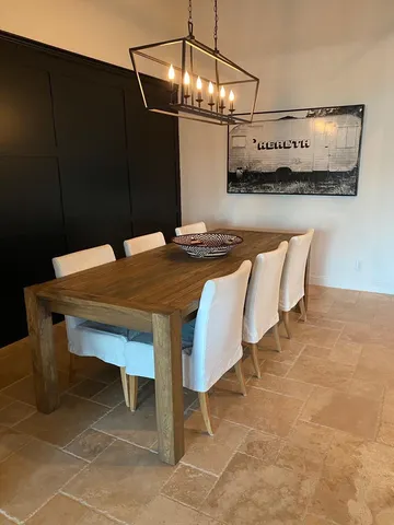 a dining room with furniture and a window
