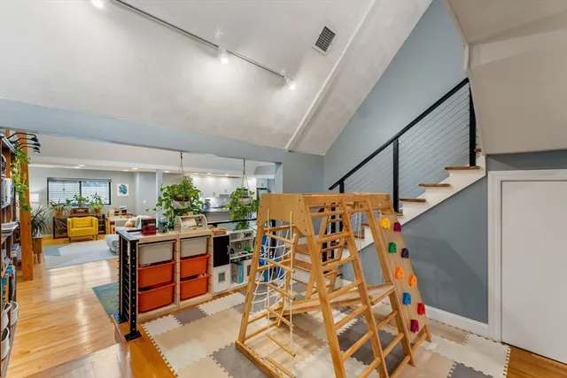 a view of a living room with furniture and wooden floor