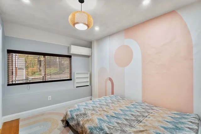 a bedroom with a bed and a large window