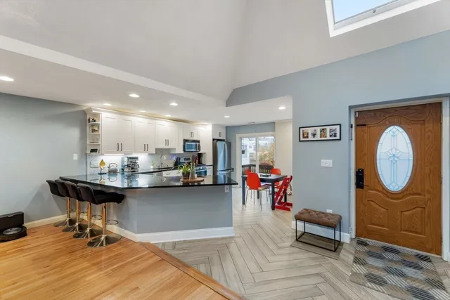 a view of a dining room with furniture and chandelier