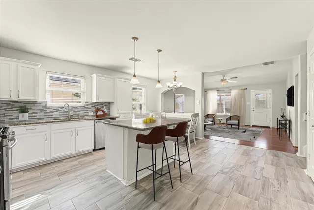 a kitchen with sink cabinets and wooden floor