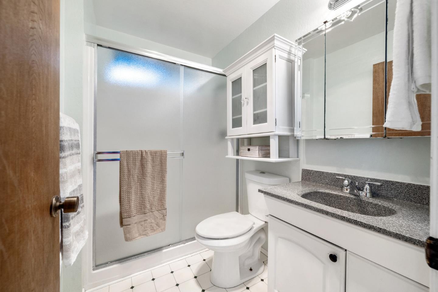 290 Olympian Way Pacifica, CA 94044 - Photo 19 of 33 a bathroom with a granite countertop sink toilet and shower