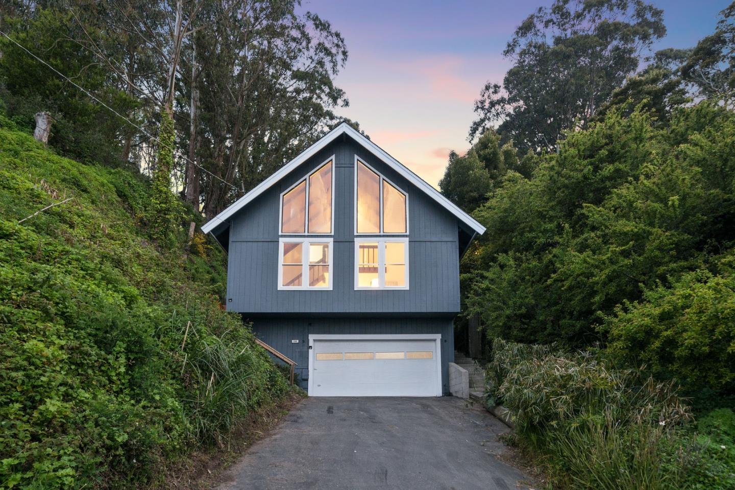 290 Olympian Way Pacifica, CA 94044 - Photo 25 of 33 a front view of a house with a yard and garage