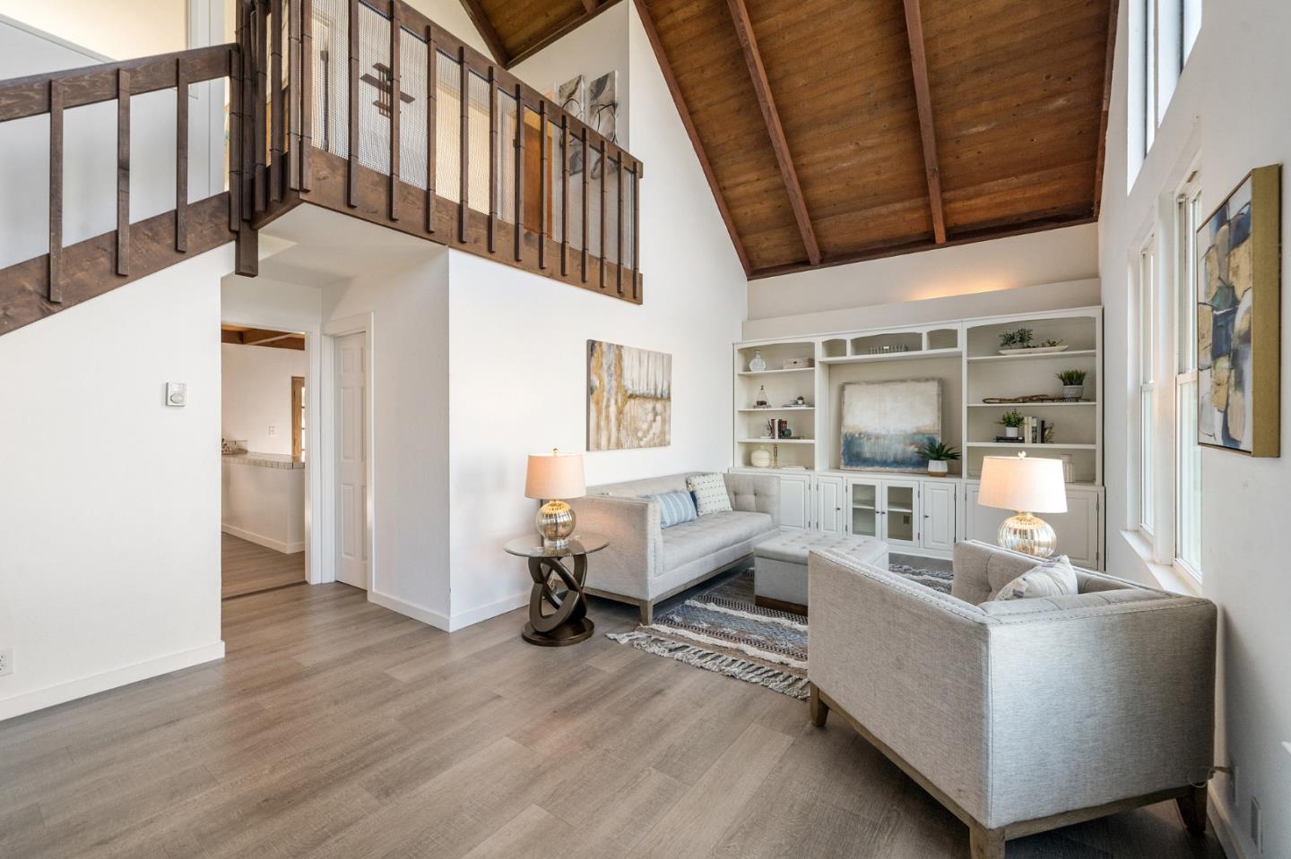 290 Olympian Way Pacifica, CA 94044 - Photo 7 of 33 a living room with furniture stairs and a wooden floor