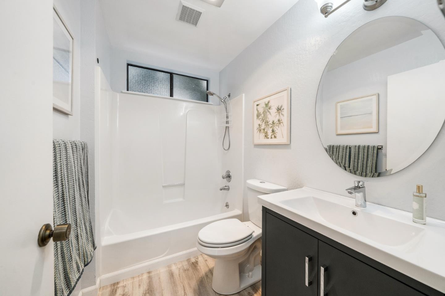 290 Olympian Way Pacifica, CA 94044 - Photo 8 of 33 a bathroom with a toilet sink a mirror and shower