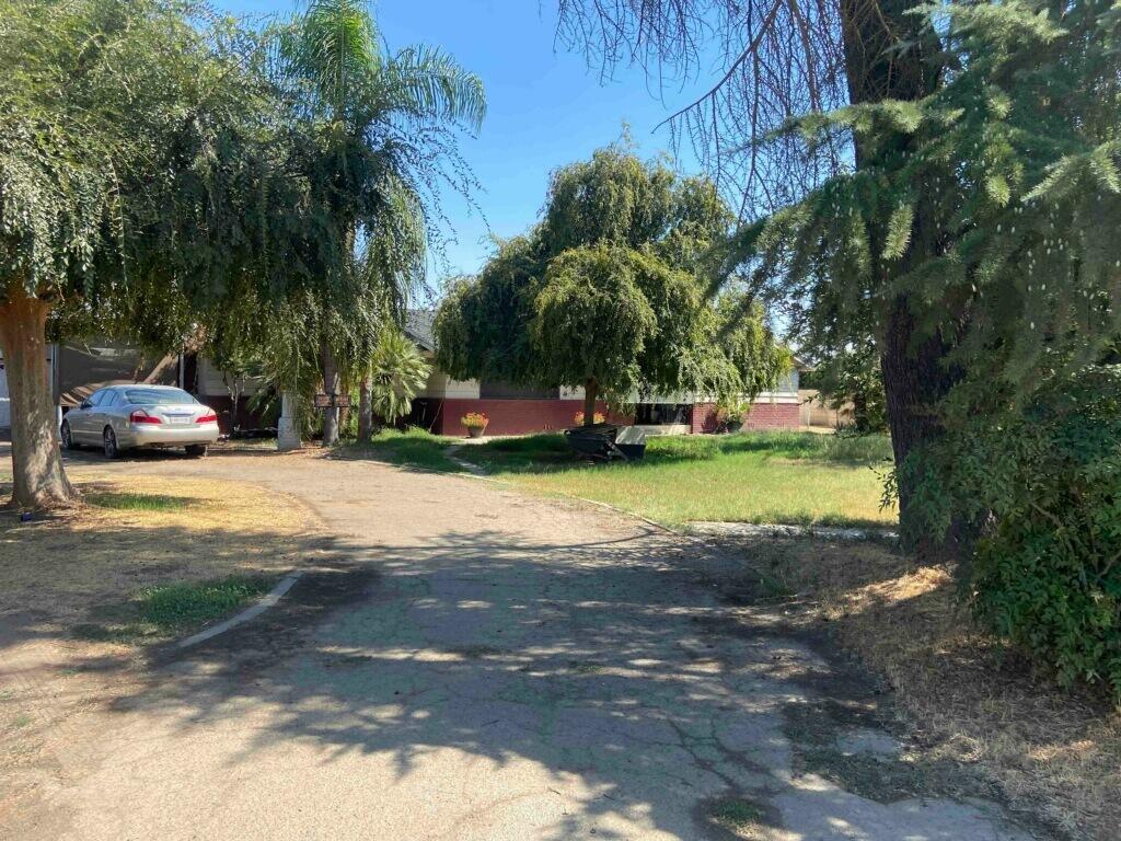 21811 Highway 198 Exeter, CA 93221 - Photo 4 of 6 a view of yard with swimming pool and trees in the background