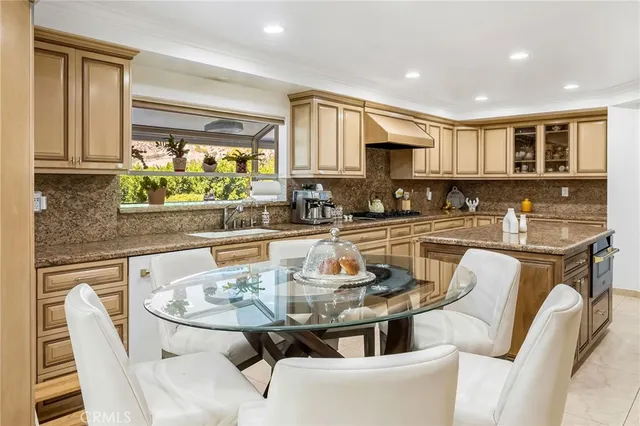 a kitchen with a stove a sink a microwave and dining table