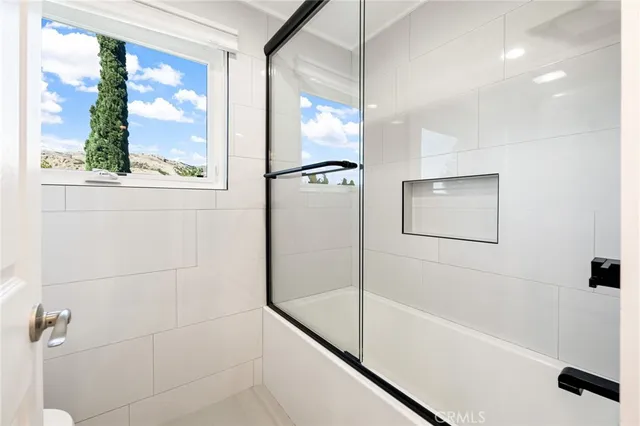a bathroom with a bathtub and a shower