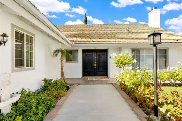 a view of a house with potted plants