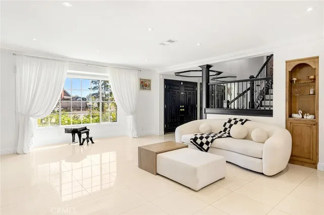 a living room with furniture and a large window