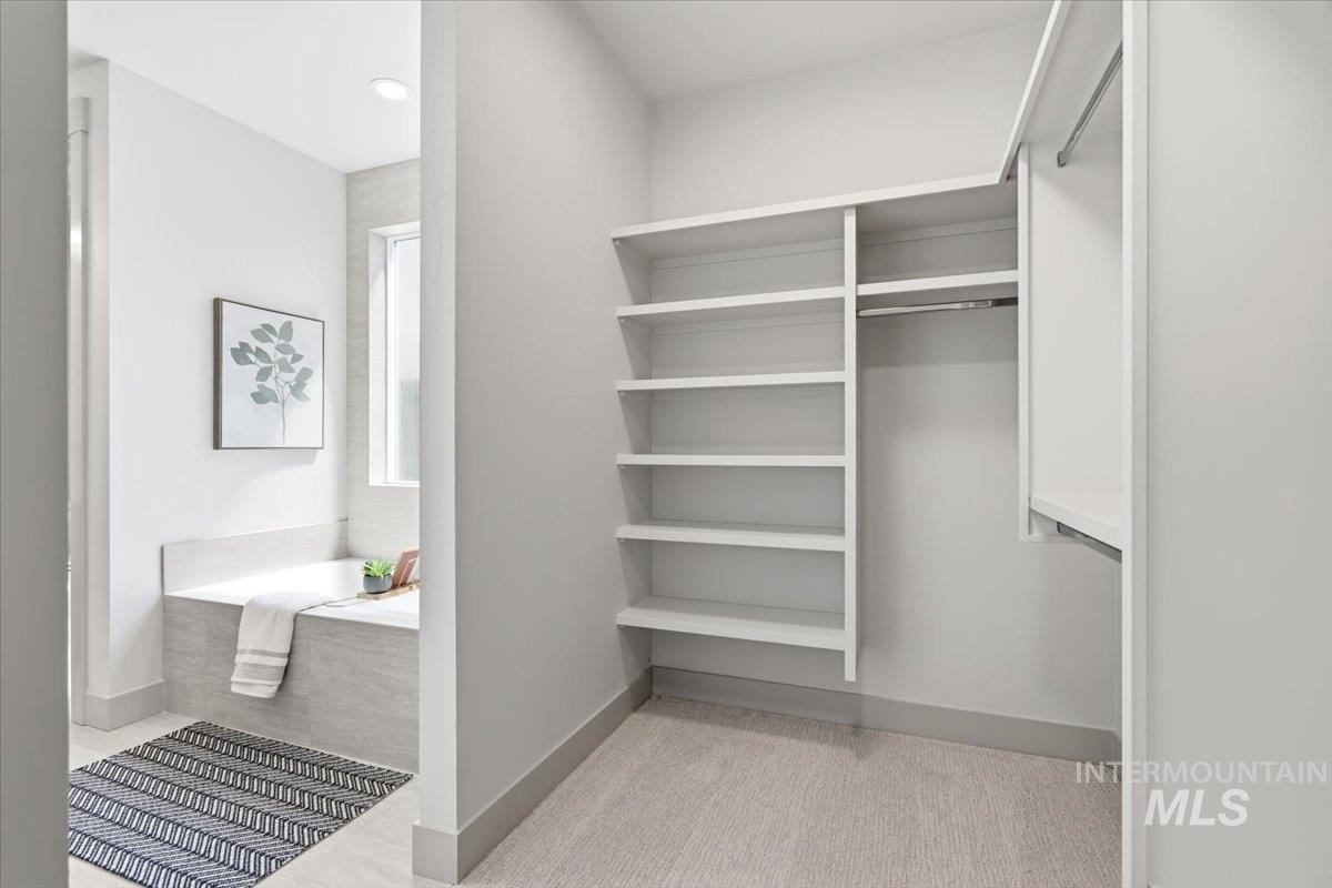 6762 South Messner Way Meridian, ID 83642 - Photo 28 of 35 Walk-in closet featuring extensive built-in shelving and dual hanging rods
