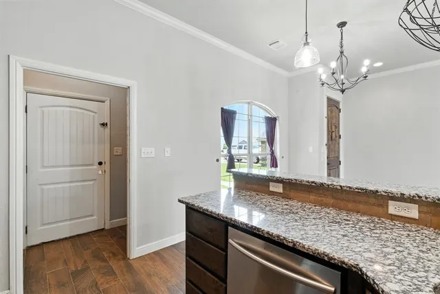 a view of a kitchen with granite countertop cabinets and wooden floor