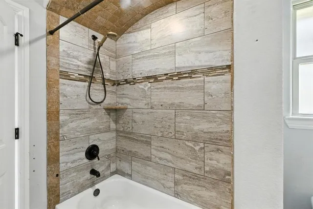 a bathroom with a glass shower door