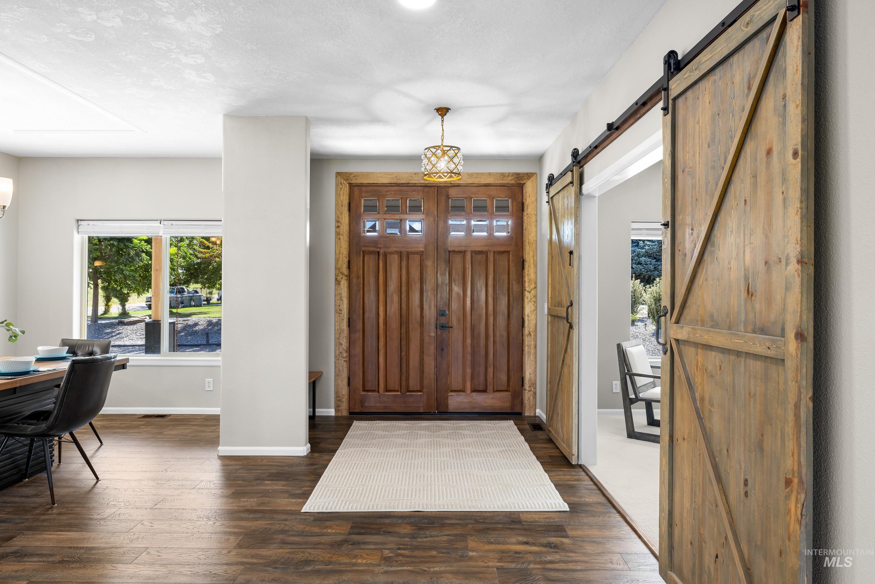 14119 Silver Ridge Road Caldwell, ID 83607 - Photo 6 of 50 Entrance foyer with dark wood-style flooring and a textured ceiling