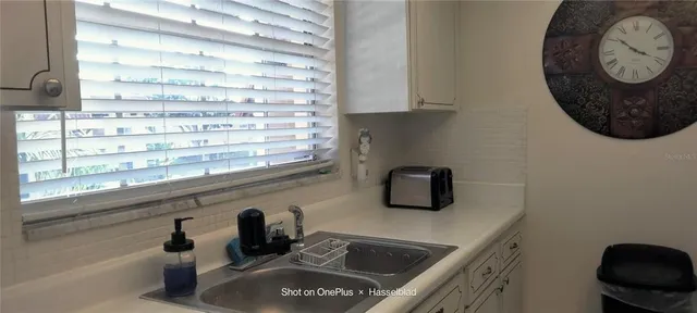 a kitchen with a sink and a mirror