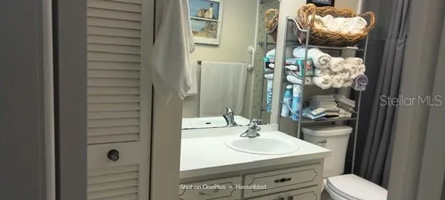 a bathroom with a sink vanity mirror and toilet
