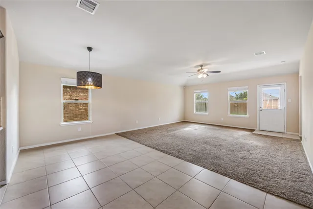 an empty room with windows and pillars in it