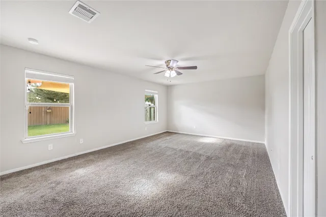 an empty room with windows and closet