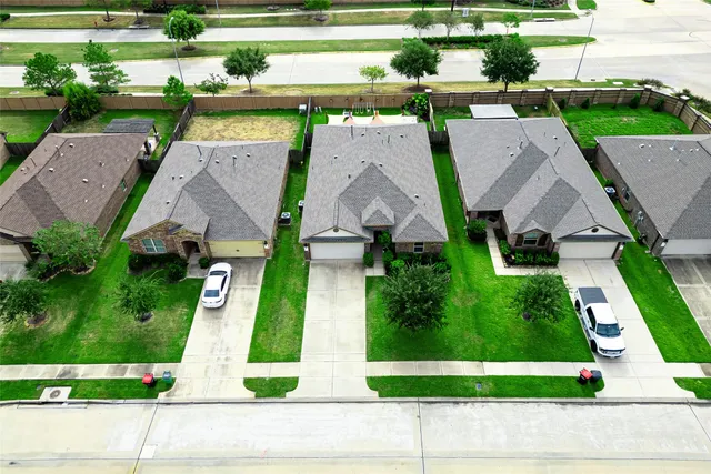 an aerial view of a house with a yard and potted plants